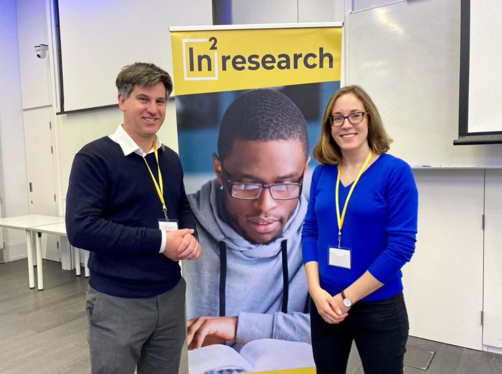 2 members of the RNID research team pictured at an event