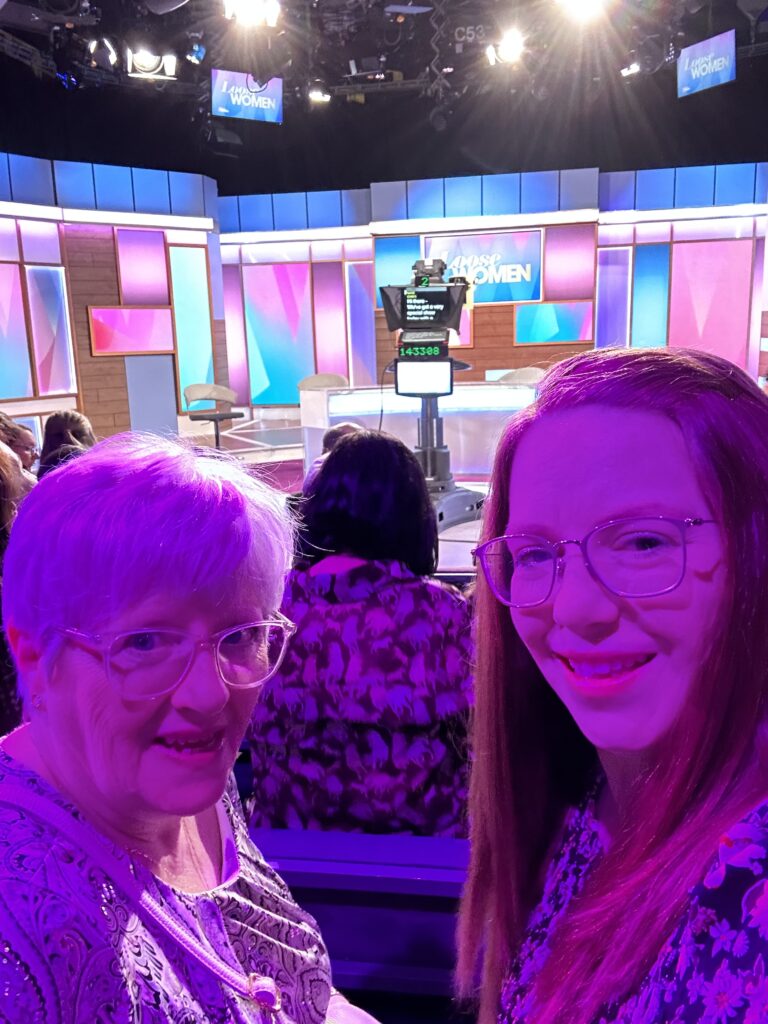 Two women in the audience of Loose Women studio, smiling at the camera.