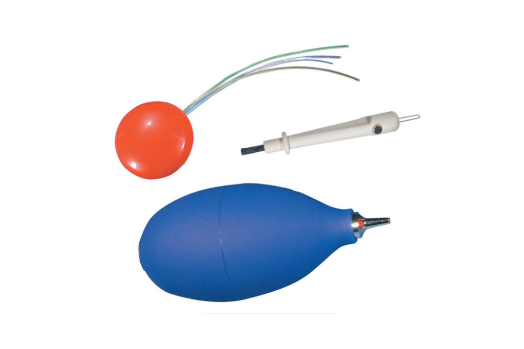 Three plastic tools used for cleaning hearing aids