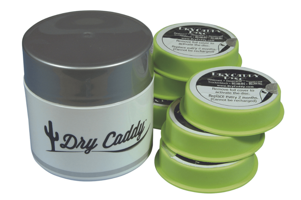 A grey circular container and stacks of green 'dry caddy' discs.
