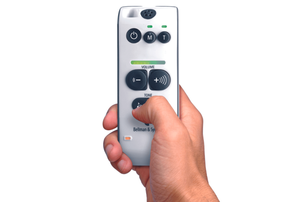 A hand held remote with six buttons on it and various lights. 