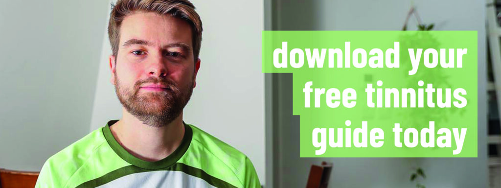 A photo of a man with a beard looking at the camera in an RNID tshirt, with the slogan: "download your free tinnitus guide today".