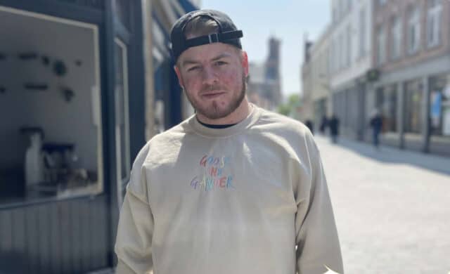 Macauley, an RNID supporter with hearing loss, wears a backwards cap and looks into the camera.