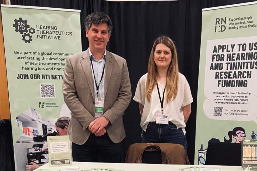 Dr Ralph Holme, RNID Director of Research, and Dr Melissa Hayman, RNID Hearing Therapeutics Manager, at an RNID exhibition stand